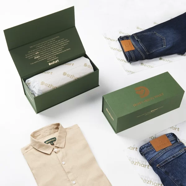 DEZHART clothing items, including a neatly folded shirt and a pair of jeans, displayed with their elegant packaging by SITL Enterprise LLC.”