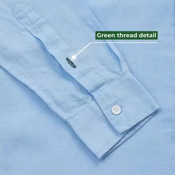 DEZHART light blue shirt with distinctive green thread detail, embodying SITL Enterprise LLC’s ethos of trust.”