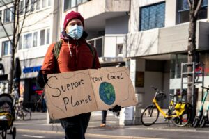 Individual Holding a Sign Advocating for Environmental Support